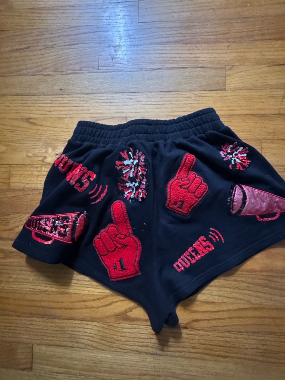 QUEEN OF SPARKLES Black Shorts with Red Pom & Foam-Finger Appliqués